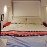 Lowered electric bed in stealth Sprinter conversion