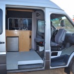 DIY Sprinter camper van interior, showing swiveling front seats (photo: 3Up Adventures)