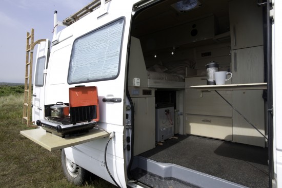 Multiple flip-up tables in Peter's Sprinter conversion.